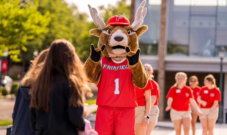 A Lucas the Stag mascot poses with his hands in a stag position.