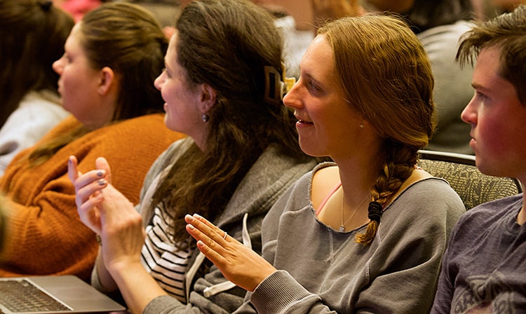 Audience members clapping after the conclusion of a diversity series speaker's lecture.