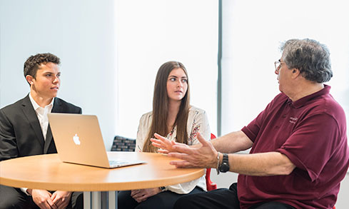 Professor conversing with students