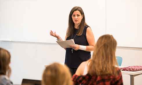 A faculty member teaching in front of a class of students.