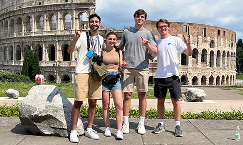  Fairfield University students studying abroad in Italy — and posing in front of the Colosseum ruins.