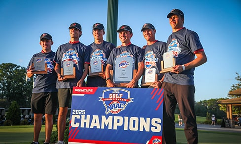 Team of six student-athletes posing with their 2025 MAAC Champions banner and awards for men's golf.