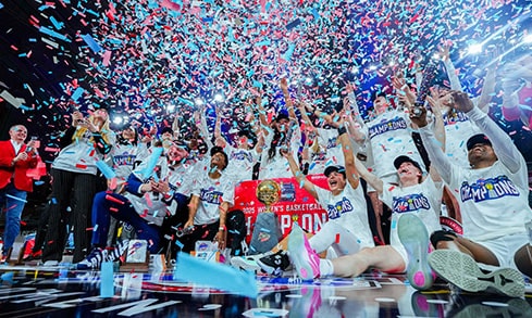 The Women's Basketball team celebrating their MAAC Championship win surrounded by confetti.