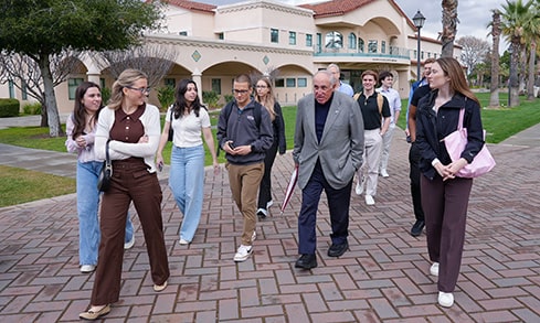 Fairfield business students walking with Joseph Bronson ’70 through the streets of Silicon Valley during an immersion trip.