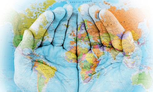 Two hands are cupped together with a world map overlay.