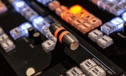 Keys on a soundboard are lit up orange and blue.