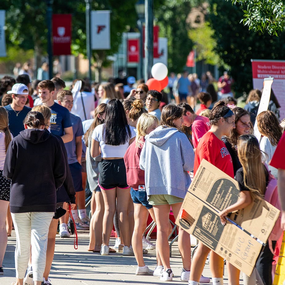 A crowd of students stand outdoors.
