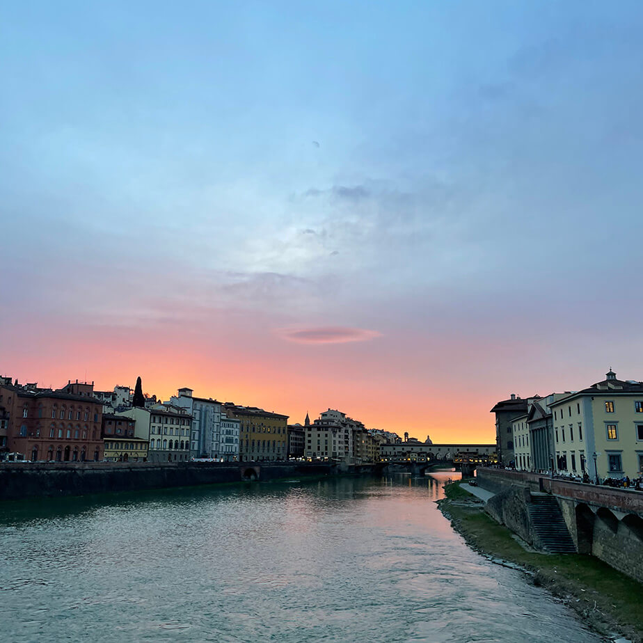 Sunset shot of the Ponte Vecchio arch bridge over the Arno river in Florence, Italy.