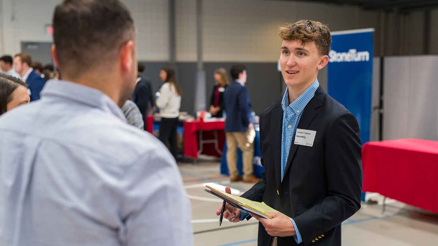 A student at a Career Fair talking to prospective employer. 