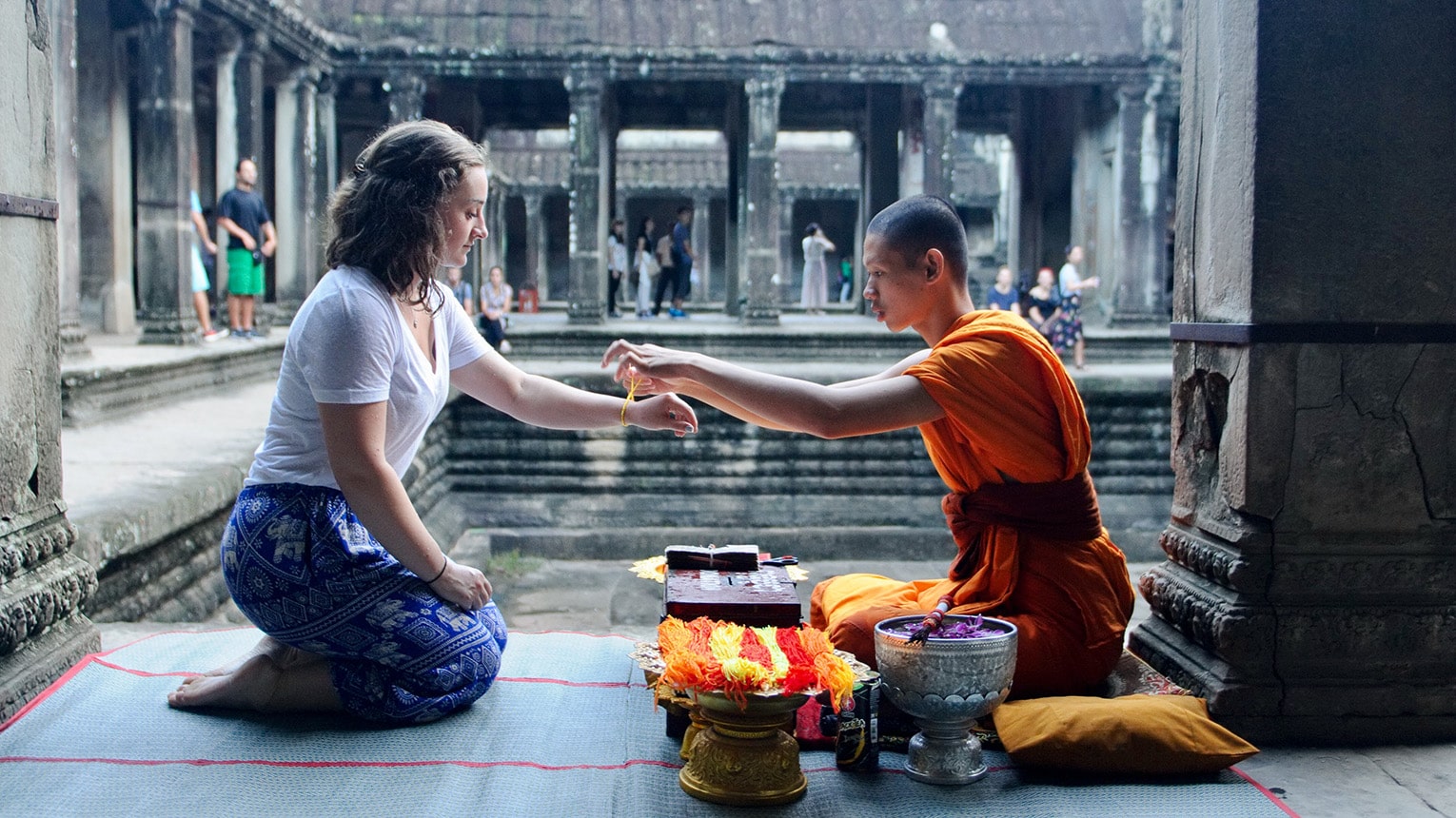 Fairfield student engaging respectfully with a Cambodian monk during meditation and prayer.