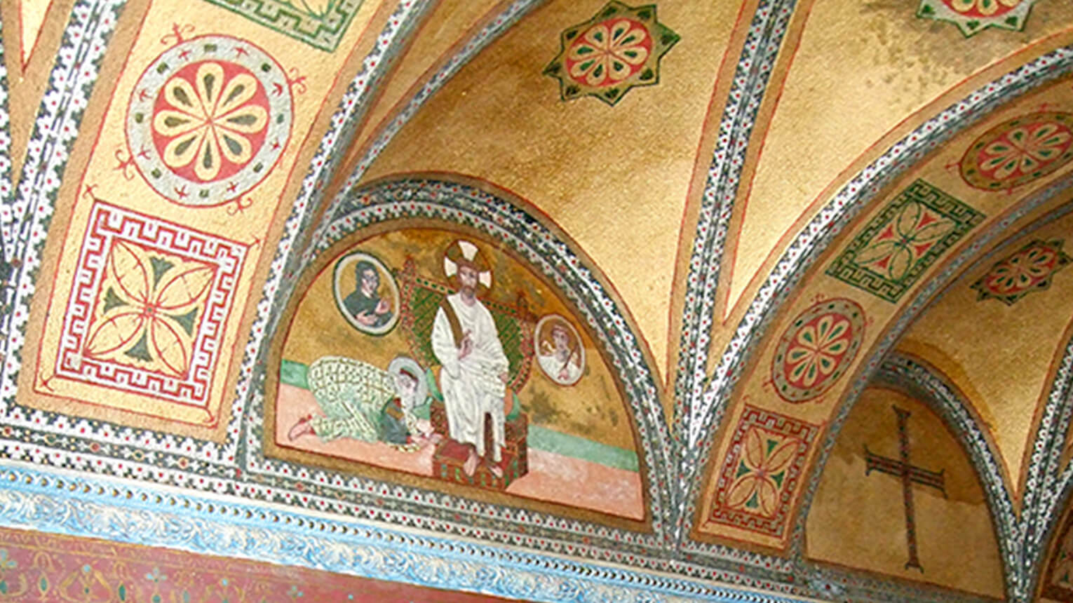 An expansive room showcasing a ceiling painted with lively, colorful artwork.  