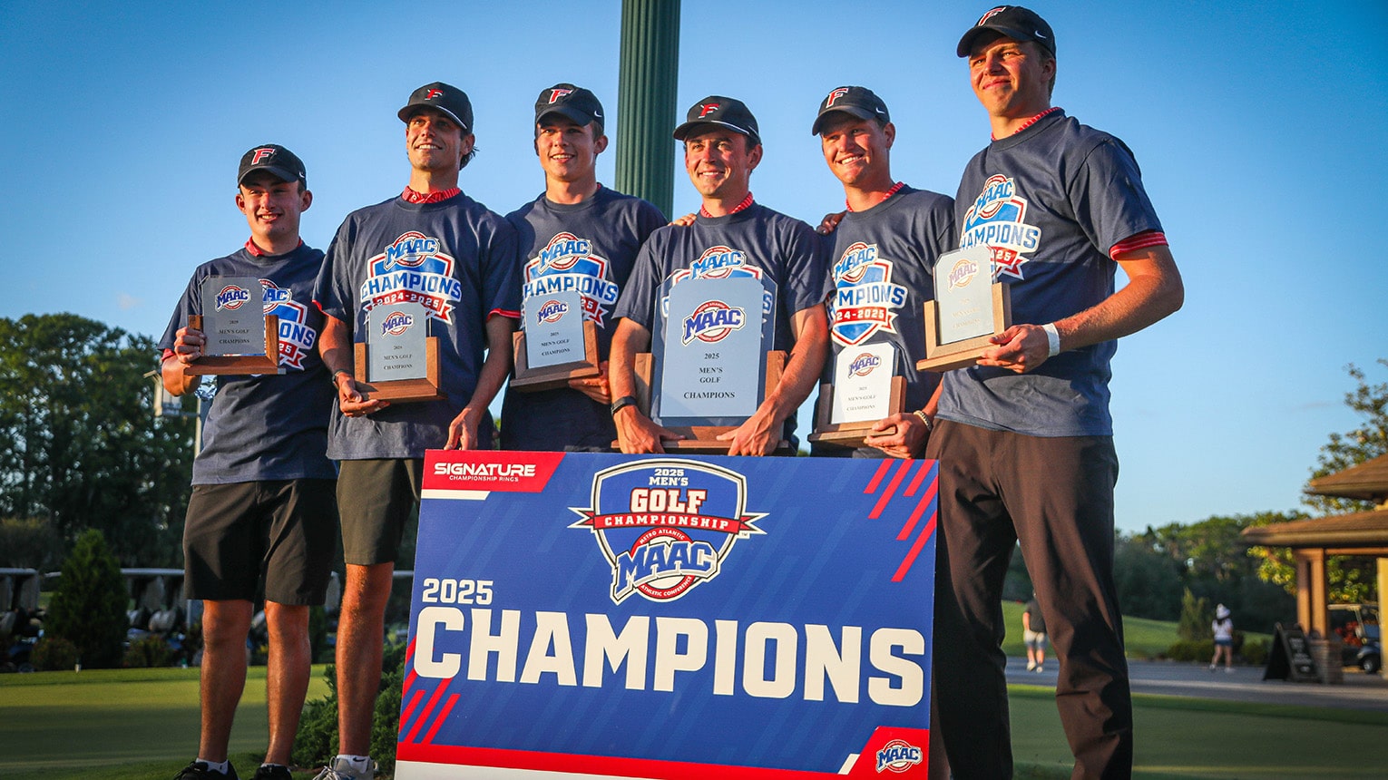 Team of six student-athletes posing with their 2025 MAAC Champions banner and awards for men's golf.
