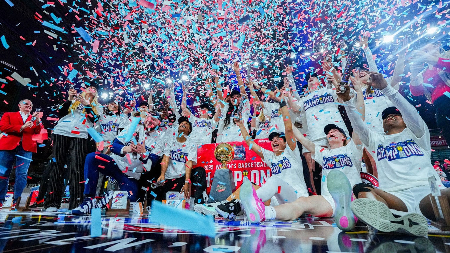 The Women's Basketball team celebrating their MAAC Championship win surrounded by confetti.