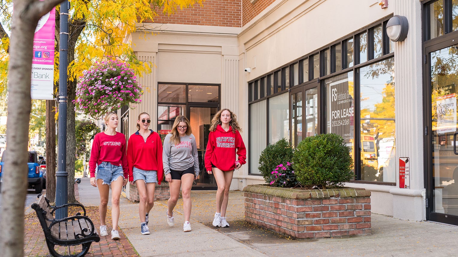 Fairfield U students walking in beautiful downtown Fairfield, which is filled with places to shop, restaurants to eat, and things to do.