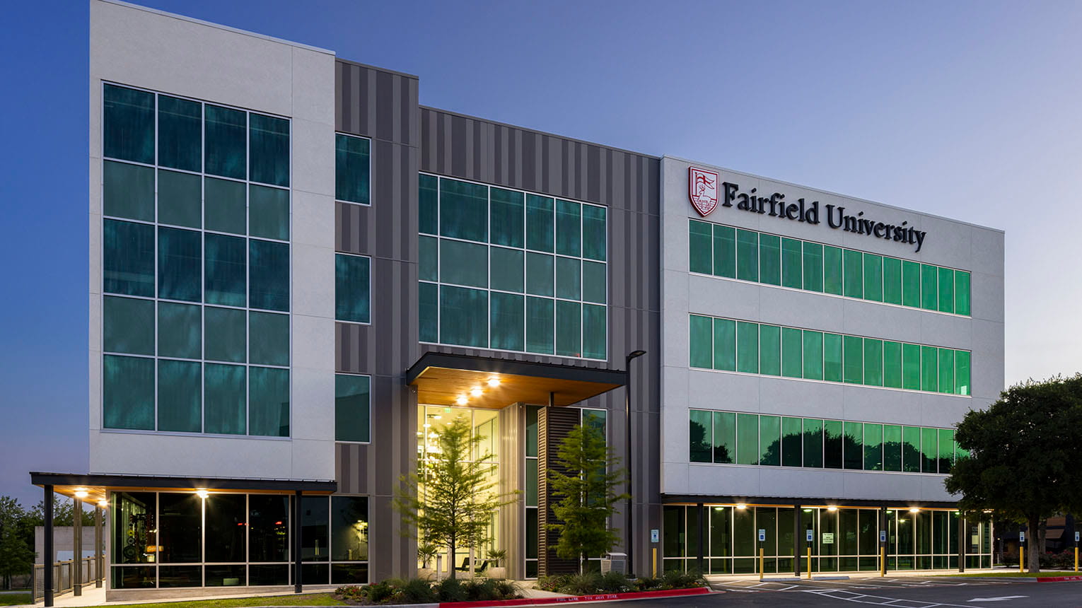 Exterior shot of the state-of-the-art, modern Fairfield campus in Austin, Texas at dusk.