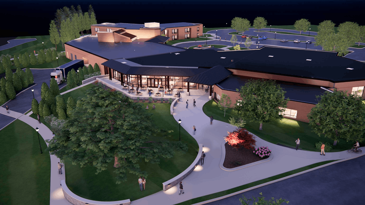 Rendering of the new two-story Corrigan Hall, captured at night to emphasize the residence hall's well-lit spaces and interior.