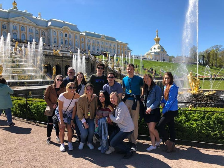 Students posing in front of the water features of the Peterhof Museum in St. Petersburg, Russia.