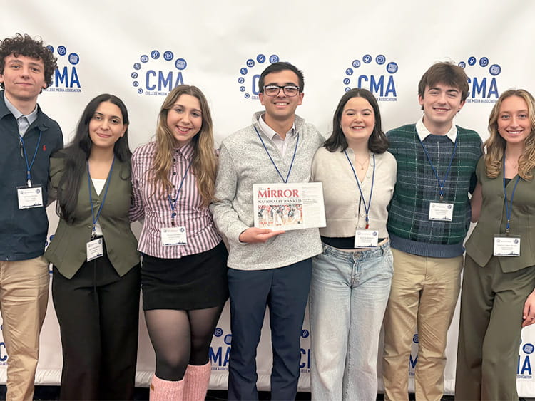 Fairfield student writers proudly holding their latest print of the 'Fairfield Mirror', which received four Apple Awards.
