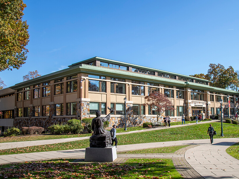 Exterior shot of the brick Library building on a clear, sunny day.