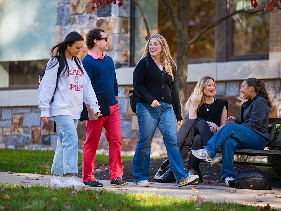 Fairfield students walking across the Dolan School of Business building pathway on their way to class.