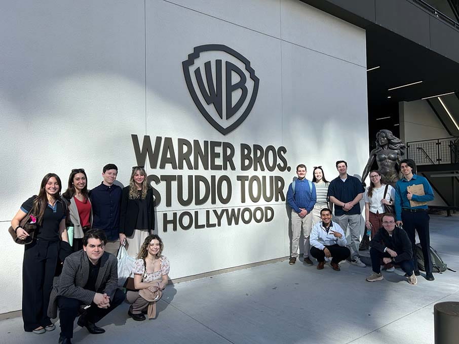 Fairfield Meditz students together in front of the Warner Bros. Studio Tour, Hollywood, sign while on the immersive Stags in LA spring break trip.