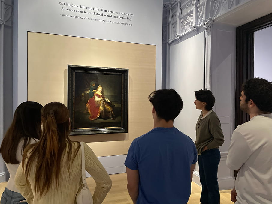 Fairfield students quietly admiring an oil painting of Queen Esther in an elegant red dress (Rembrandt) during a field trip to the Jewish Museum.
