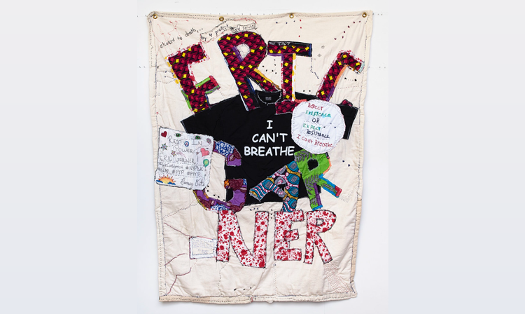 Quilit over a grey background. A black shirt with text saying "I can't breathe" is patched into the center of the artwork between abstract shapes and letters