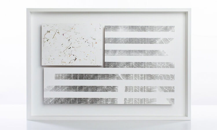 Abstract artwork features a U.S. flag design with silver stripes and a splattered paint section. The minimalist, modern piece has a sleek, sophisticated tone.