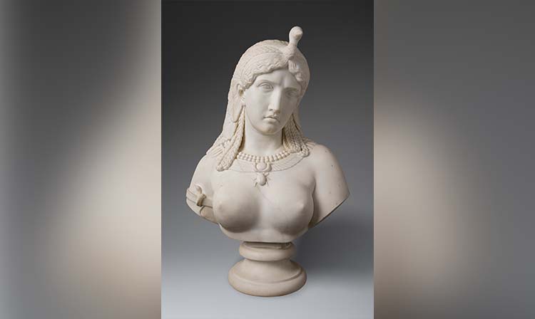 Marble bust of a regal woman adorned with a serpent headdress and pearl necklace, set against a dark gradient background, conveys elegance and mystery.