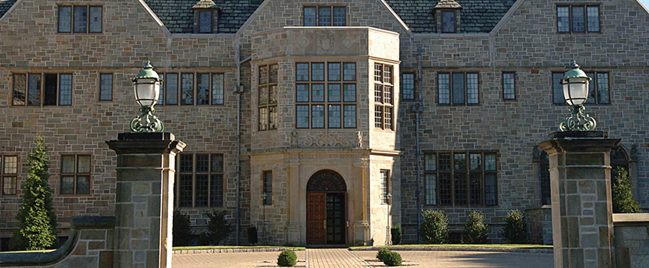 Bellarmine Hall, a large stone building with a solid structure and classic architectural features. 