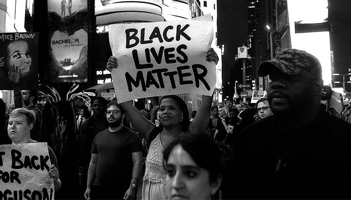 Robert Gerhardt, Protestors Marching through Times Square on the 5th Anniversary of the Death of Michael Brown, Times Square, New York City, August 9, 2019, silver gelatin print.