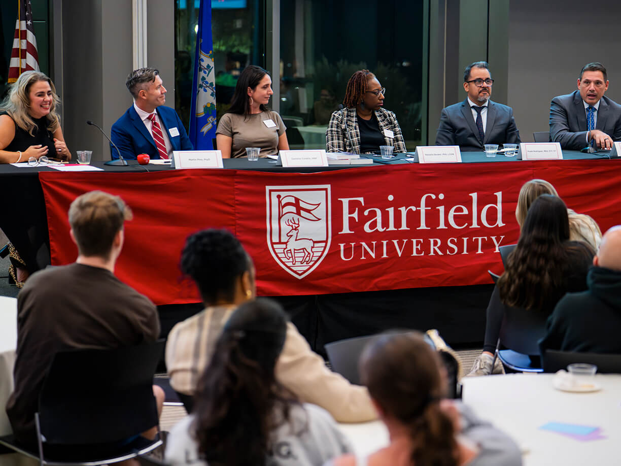 A panel discussion featuring Fairfield University faculty and others, highlighting their perspectives and collaborative dialogue.
