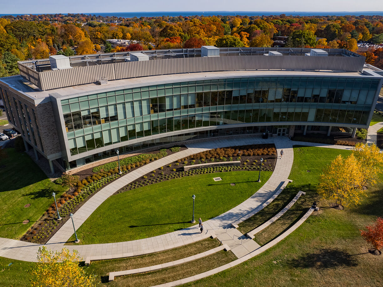 Overhead perspective of the Charles F. Dolan School of Business building, highlighting its structure and nearby greenery.