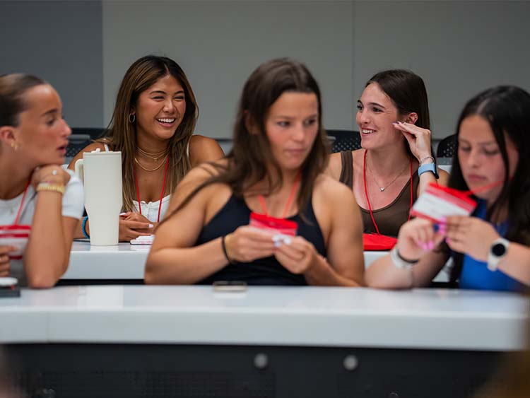 A group of women gathered at a table, sharing laughs and conversation.