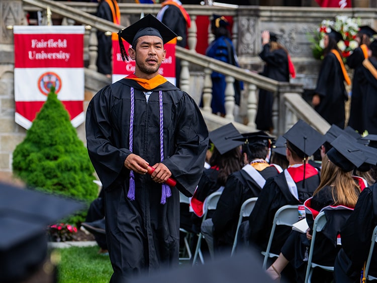 Fairfield Austin graduate returning to his seat on Bellarmine Lawn after receiving his diploma.