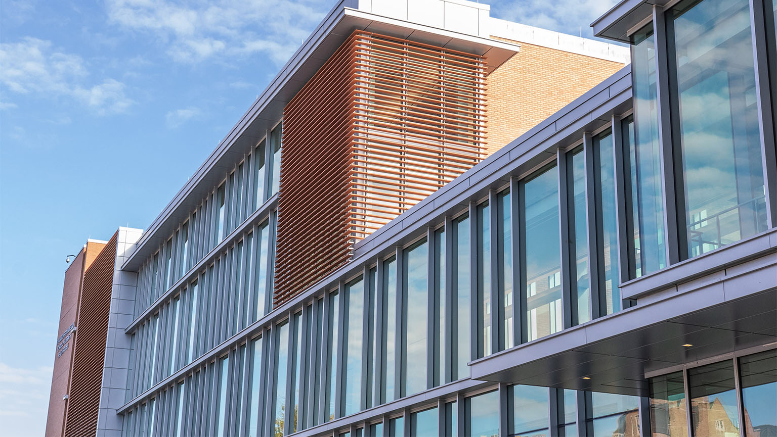 Image of the Egan Nursing School showcases a contemporary design with a large glass wall and an expansive window.