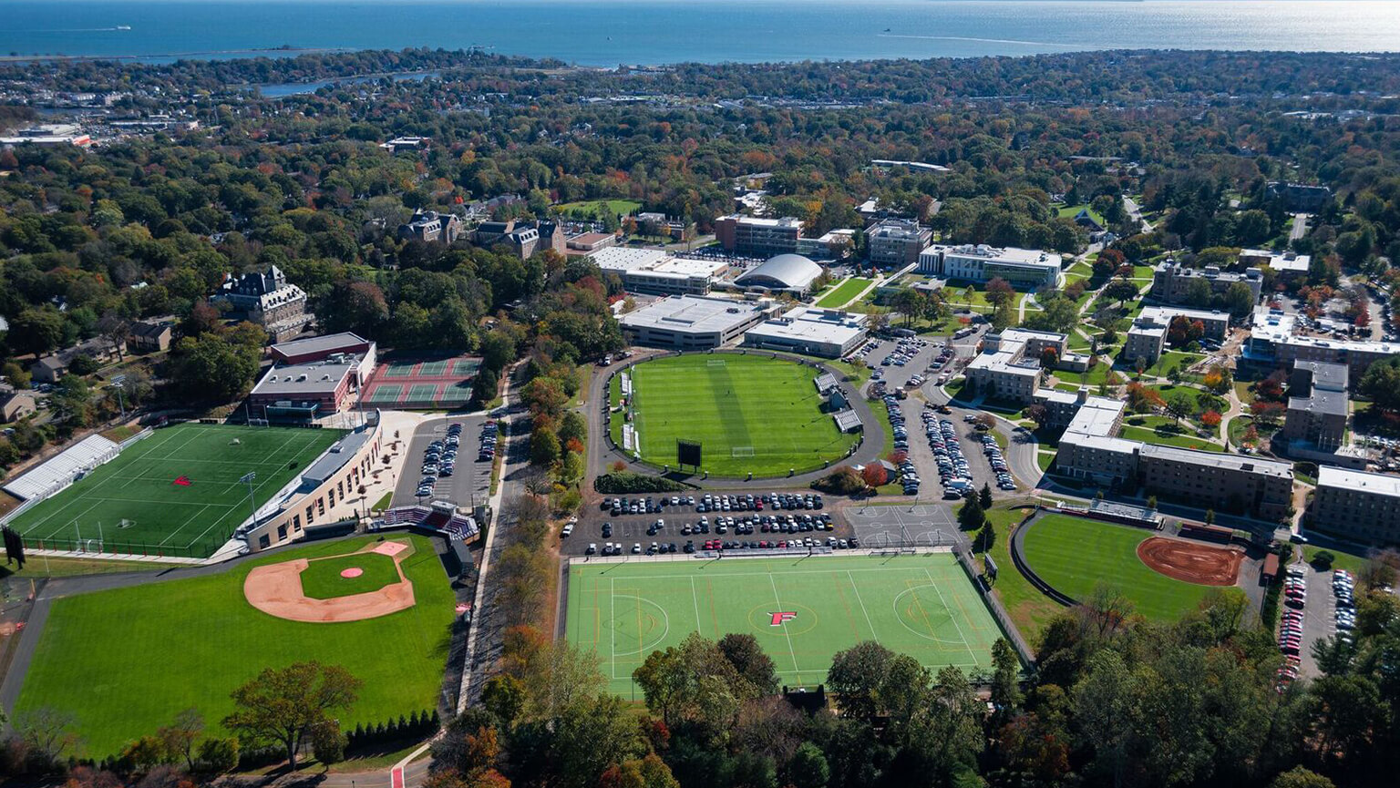 Aerial view of a Fairfield University campus featuring a baseball field surrounded by academic buildings and green spaces.