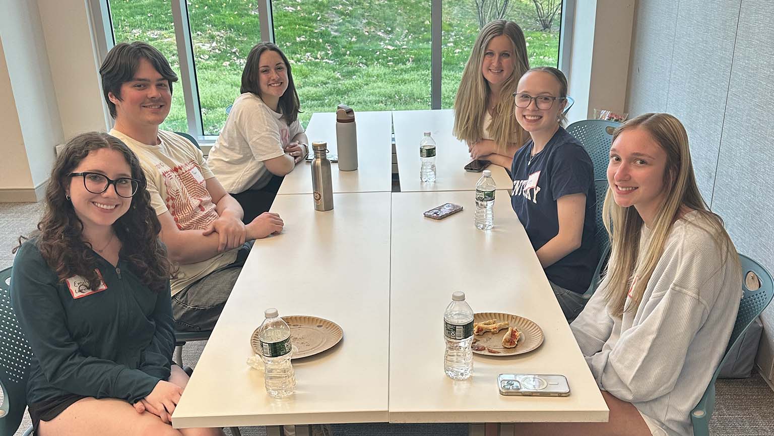 Image of students sitting around a table during a lively discussion