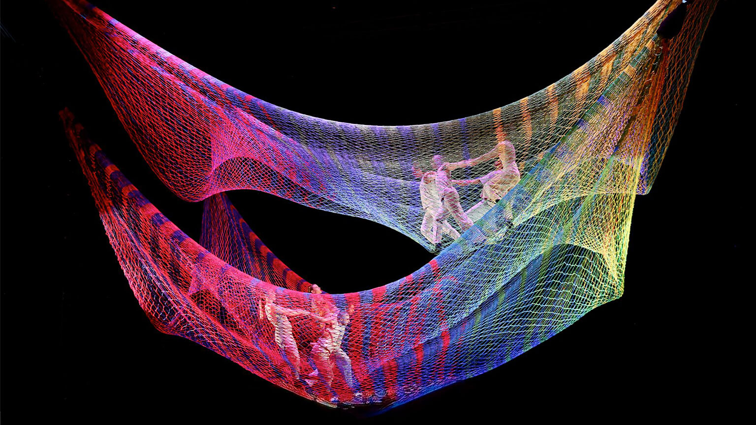 A vibrant, multicolored net displayed against a neutral background, showcasing a variety of bright hues.