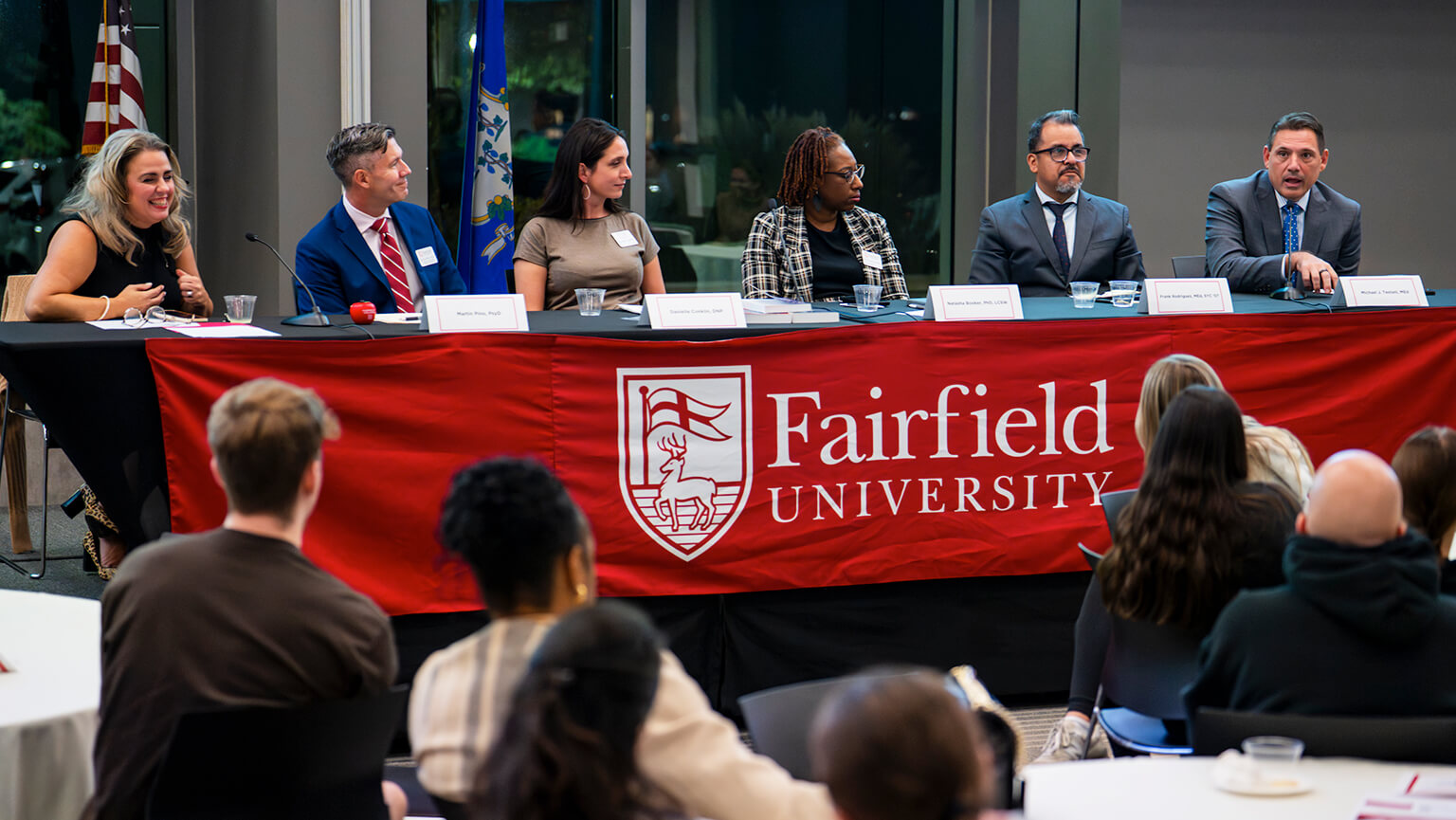 A panel discussion featuring Fairfield University faculty and others, highlighting their perspectives and collaborative dialogue.
