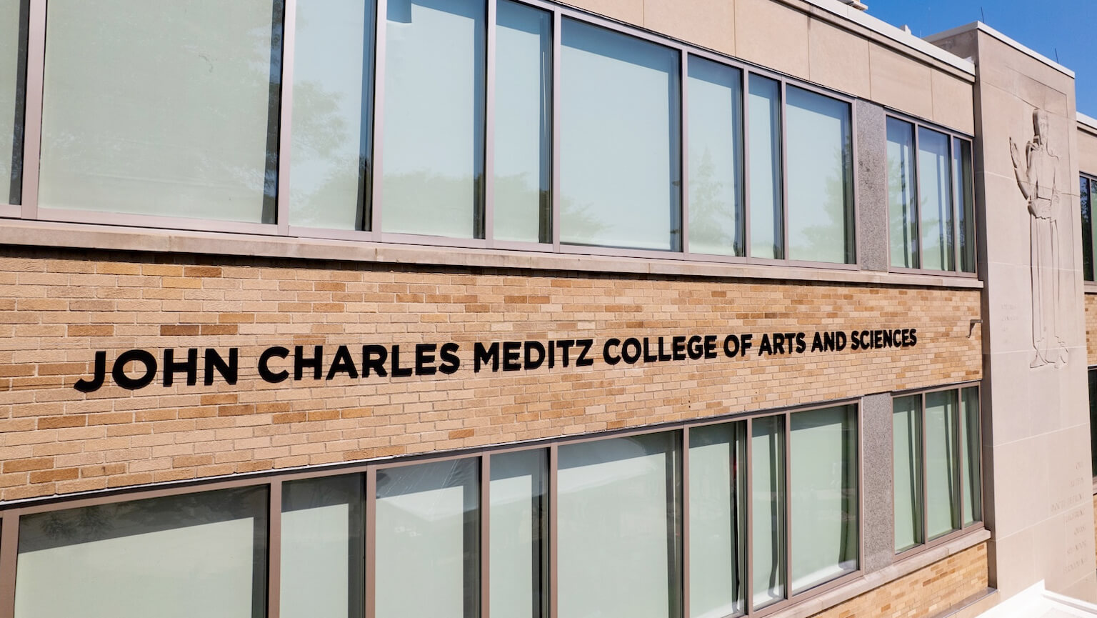 Front facade of the John Charles Meditz College of Arts and Sciences, highlighting its architectural features and inviting atmosphere.  