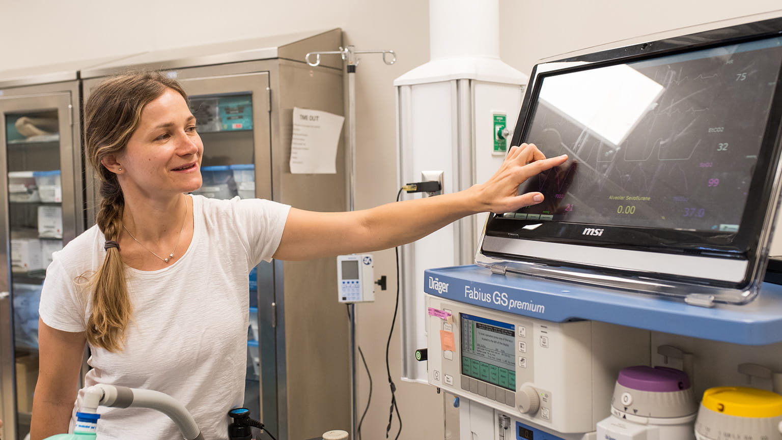 Fairfield Nursing student pointing to the screen of an anesthesia workstation.