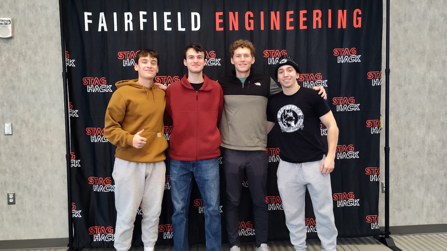 Fairfield Staghack team posing in front of a 'STAGHACK' banner.