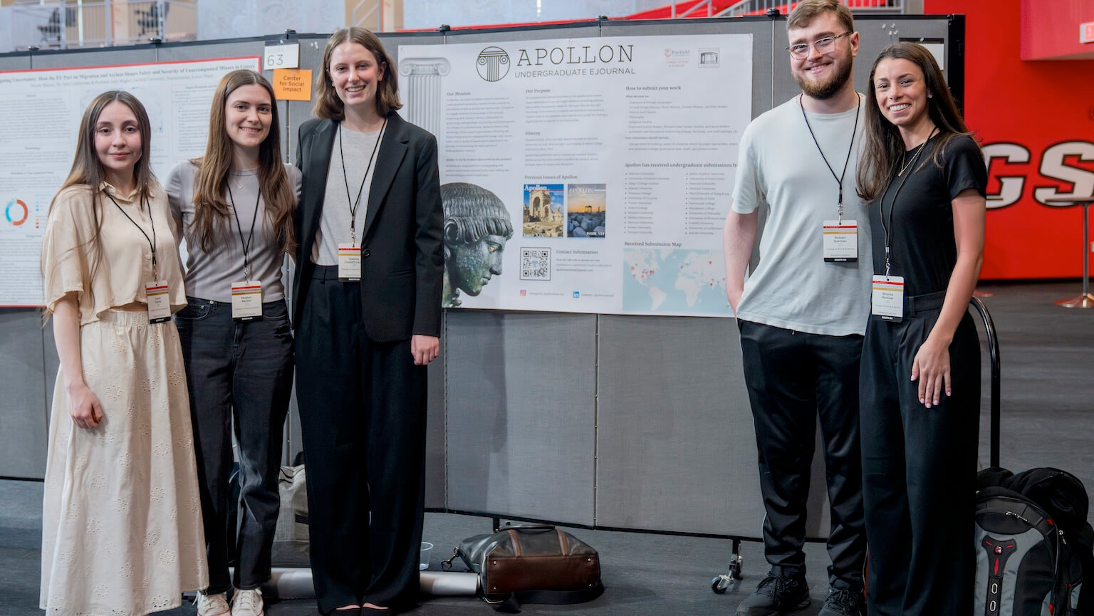 Students at the research symposium standing in front of their poster. 