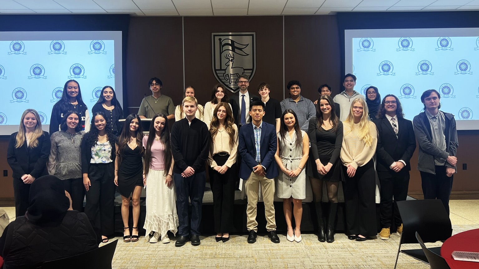 Newly-inducted members of the first-generation student Tri-Alpha honor society posing proudly.