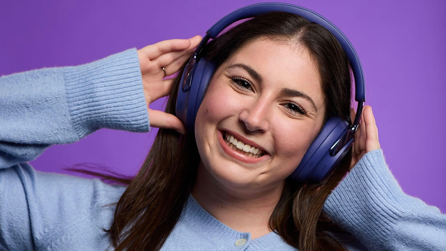 Fairfield alumna wearing a pair of Bose over-the-ear headphones.