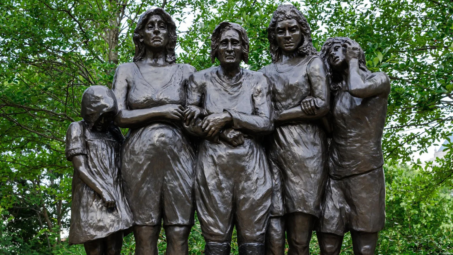 Bronze holocaust memorial sculpture of four women and a young girl.