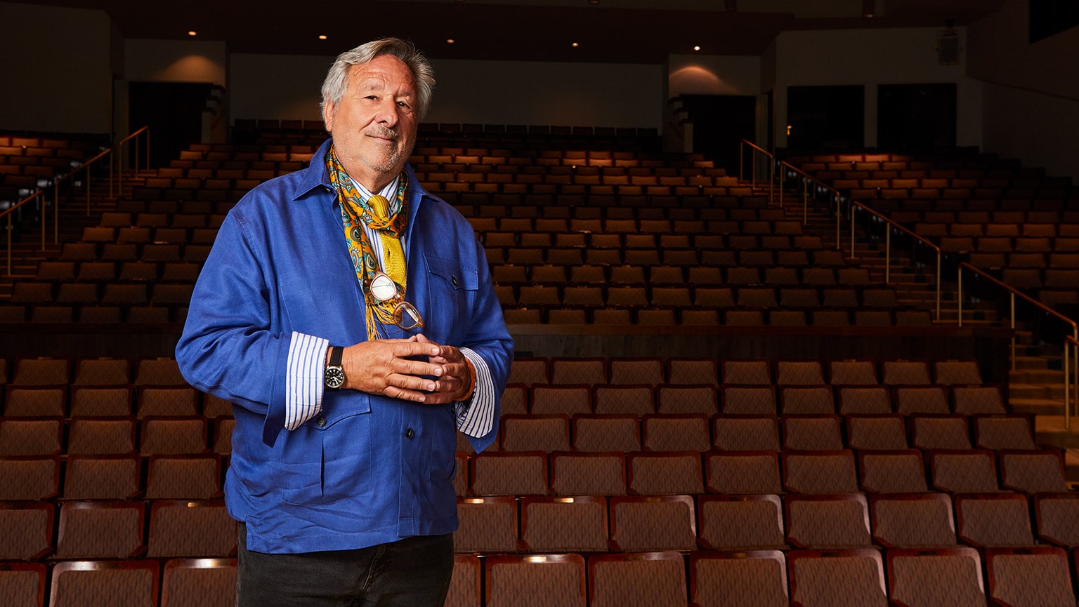 Portrait of Philip I. Eliasoph standing in an empty venue seating area prior to a lecture.