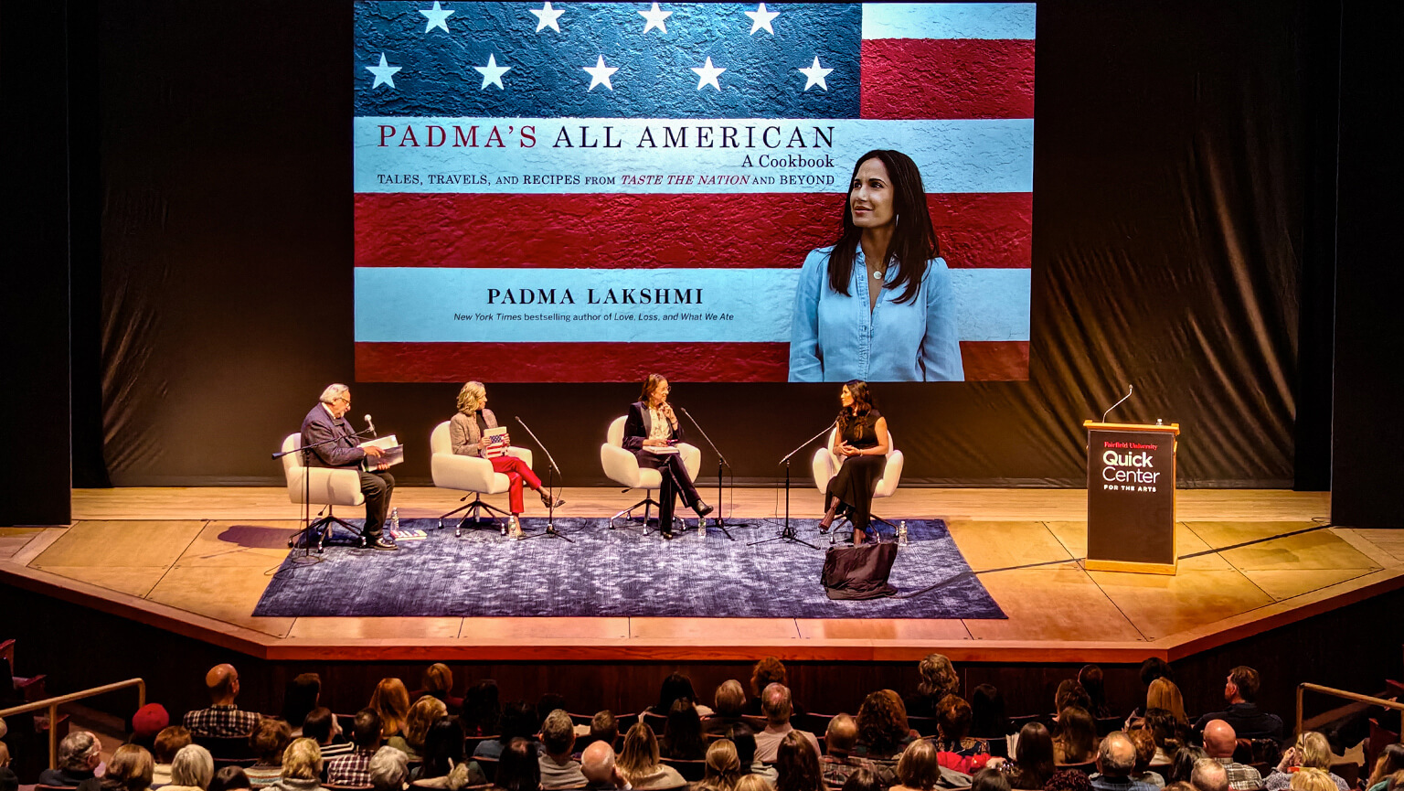 A panel discussion featuring multiple speakers on stage, sharing insights and responding to questions from the audience.