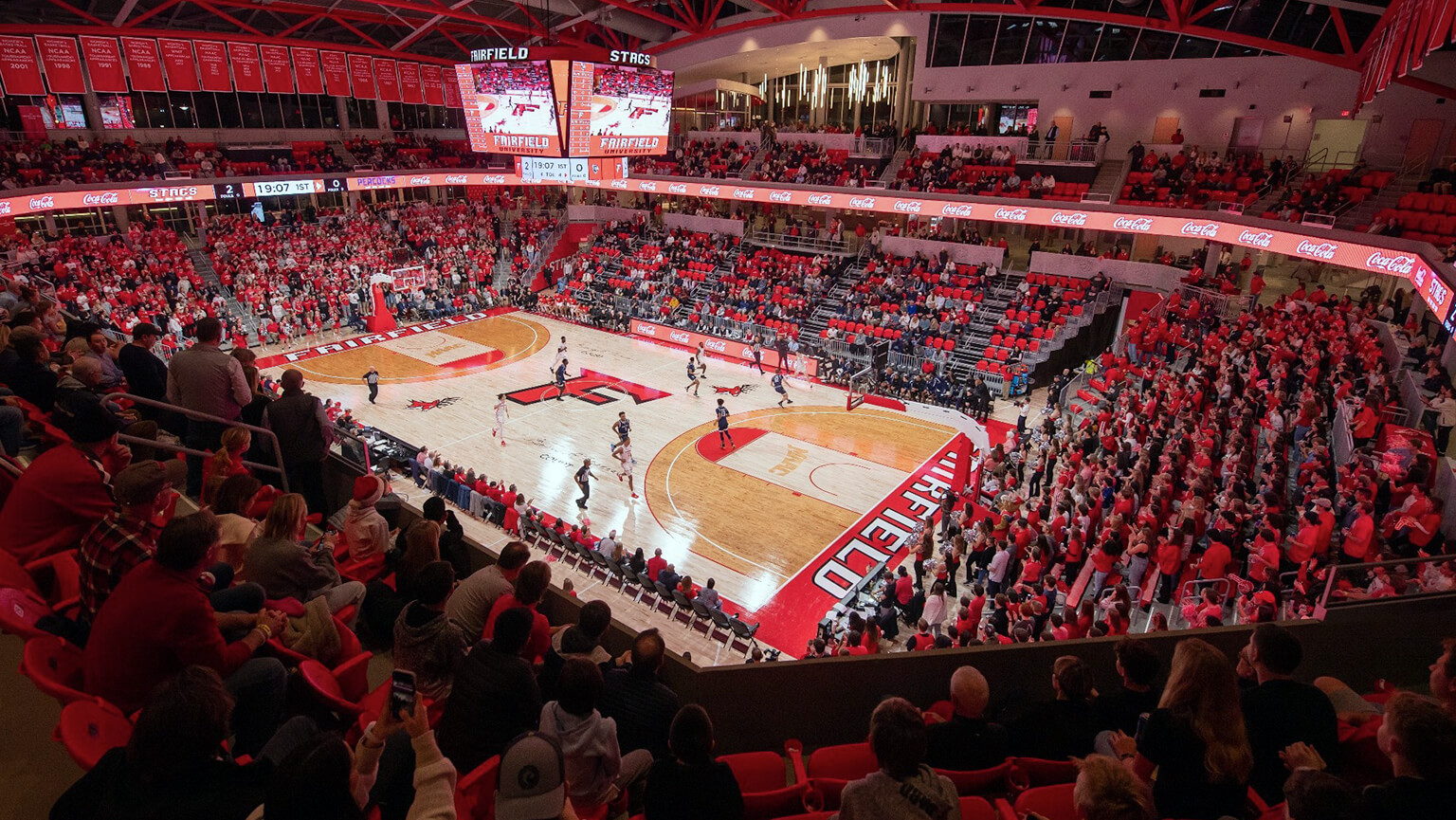 A large crowd of spectators fills the Leo D. Mahoney Arena, creating an energetic atmosphere during a game.  